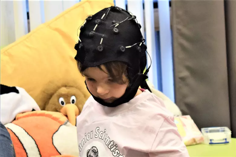 Photo of toddler wearing a brain monitoring cap